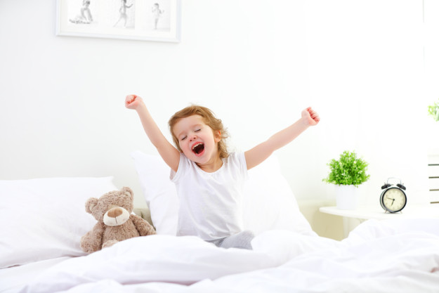 morning awakening child girl in bed